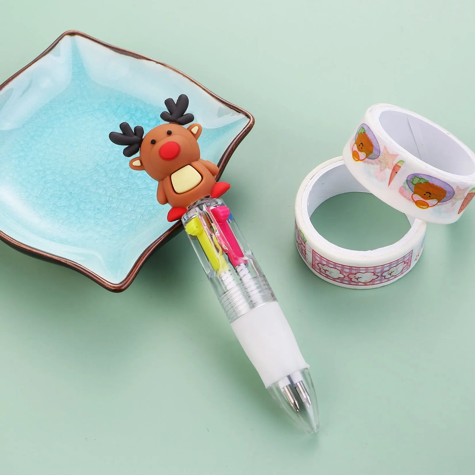 Compact 11cm Christmas four-colour press pen with festive designs including reindeer and snowmen.