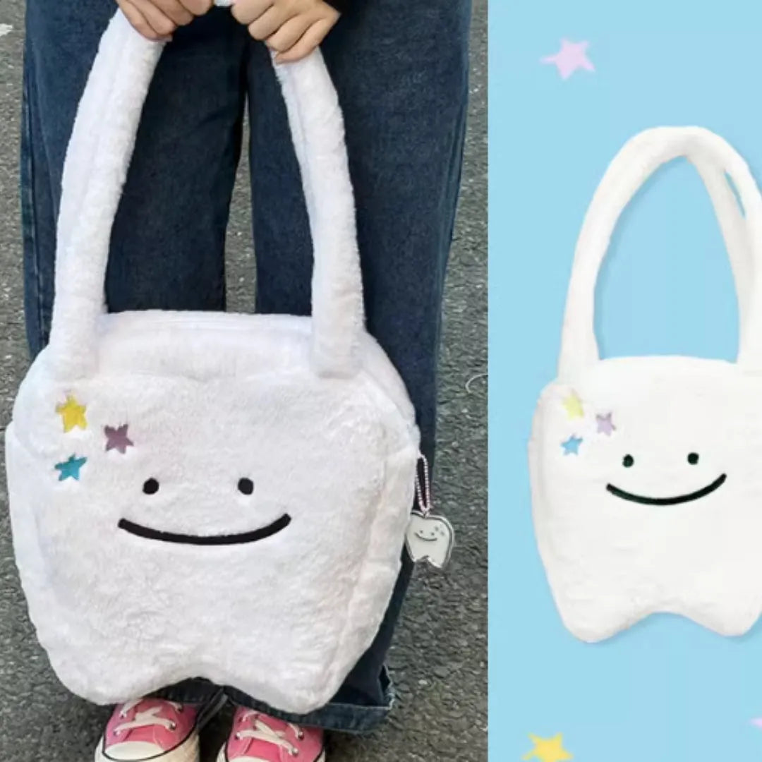 White plush large tooth shoulder tote bag with crossbody strap and zipper.