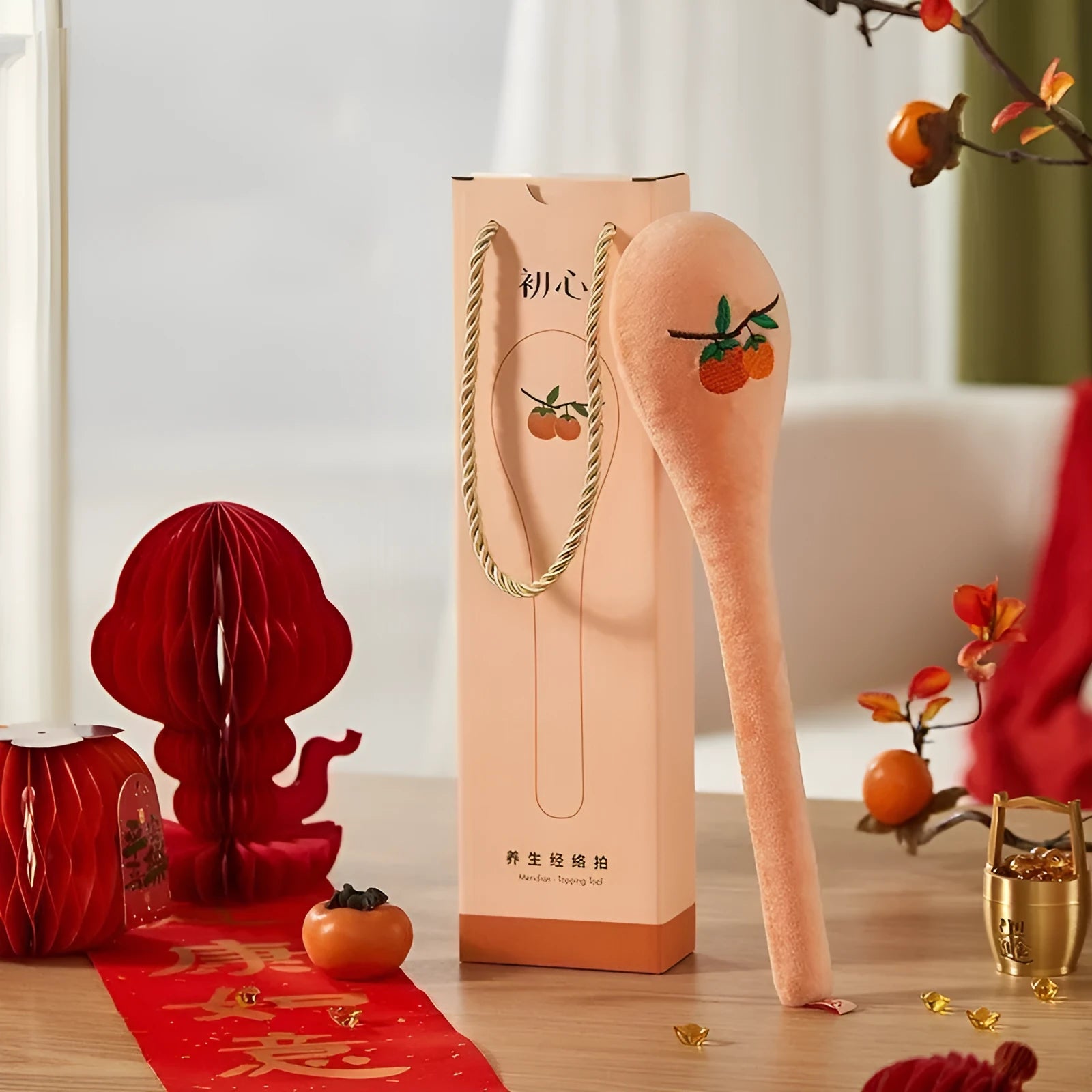 48 cm long persimmon coloured percussion massage stick with meridian flap design in a zipper case.