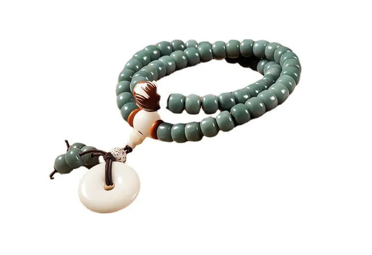 White jade and bodhi seed beaded bracelet with a double ring safety buckle clasp.
