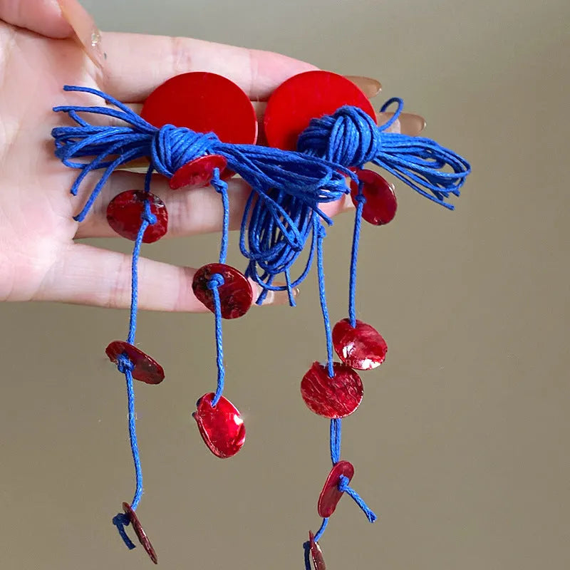 Geometric cloth hoop earrings with blue resin flower detail and manual processing