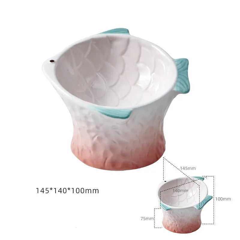 Set of four blue fish-shaped ceramic cat bowls with tilted design and elevated base