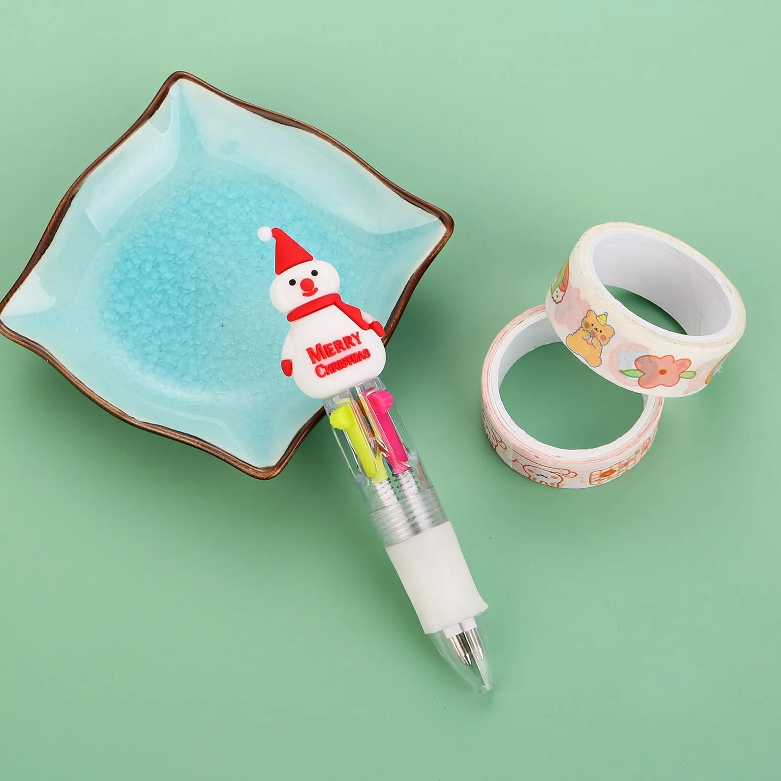 Compact 11cm Christmas four-colour press pen with festive designs including reindeer and snowmen.