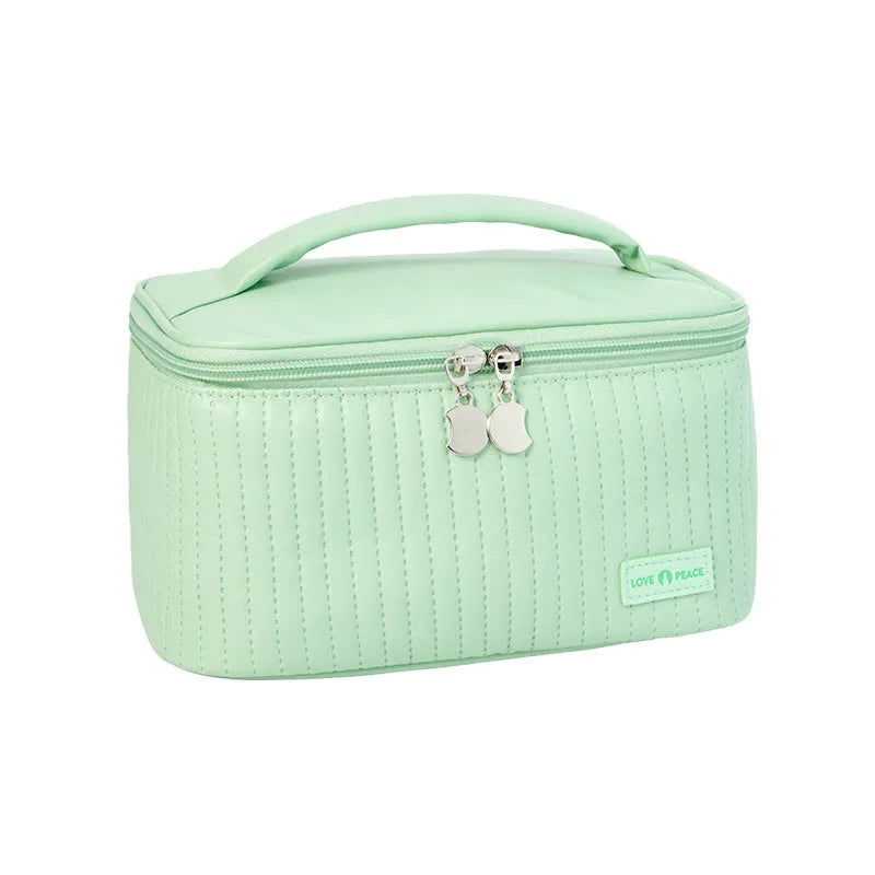 Open-top cake shaped makeup bag in solid colour PU leather, shown in a light blue colour variant.