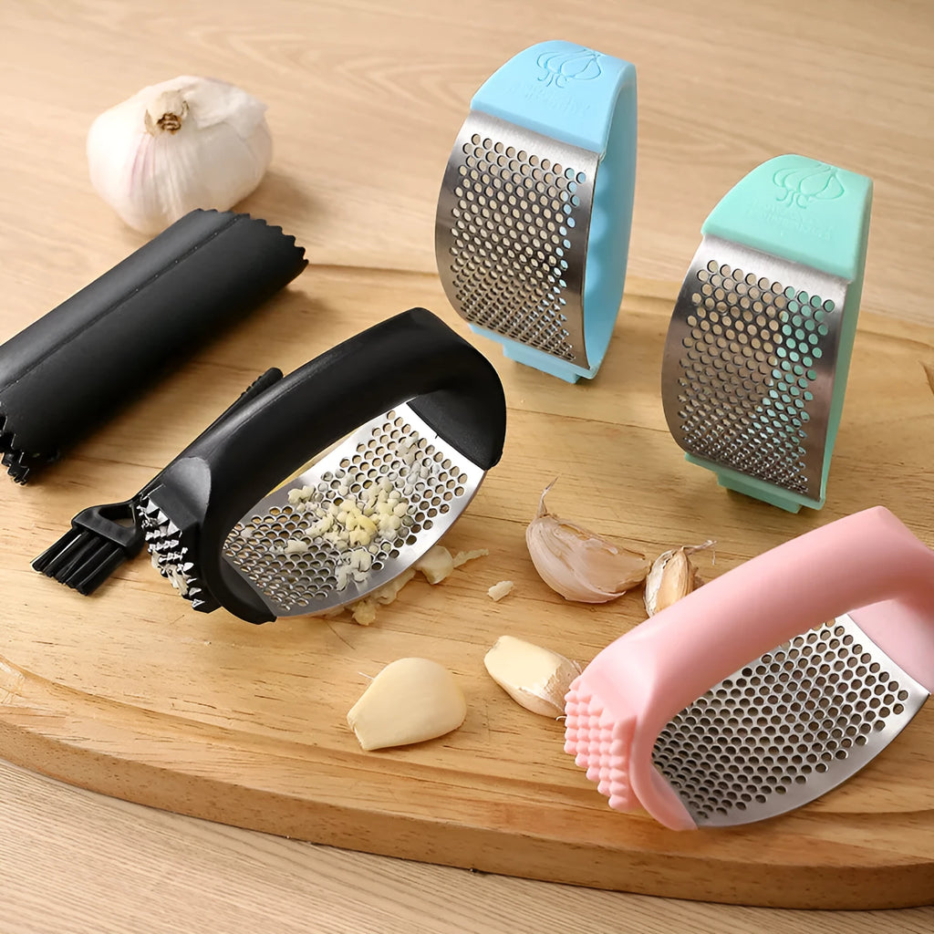 Stainless steel garlic press in green, showing compact 11cm design for crushing garlic.