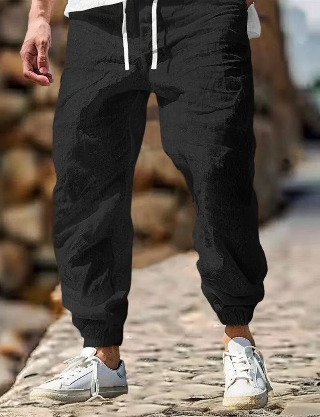 Men's straight-leg cotton trousers in apricot colour with an elastic waistband.