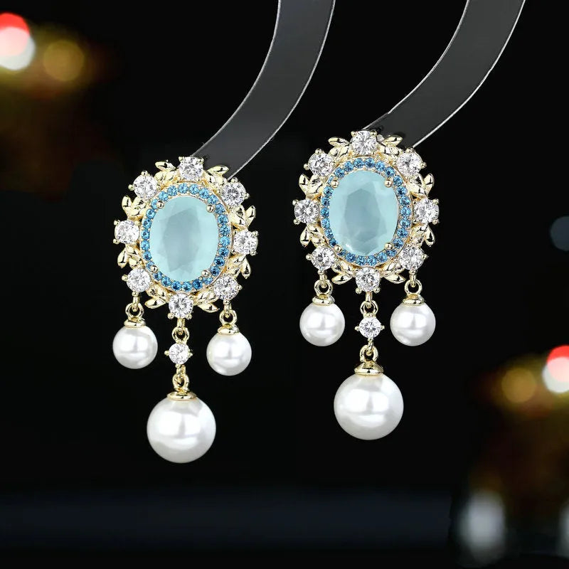 Oval zircon inlaid pearl tassel earrings in copper with geometric design and dangling elements