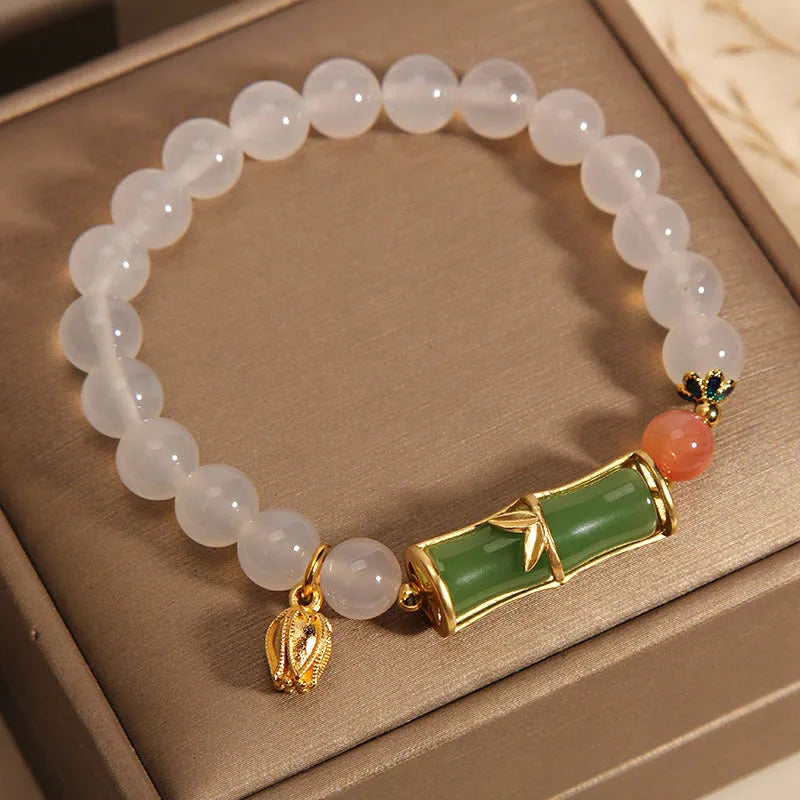 Women's white agate jasper bamboo bead bracelet with a single central jade focal bead.