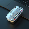 Carbon fibre style car key cover with mirror in feilin material, shown in carbon colour.