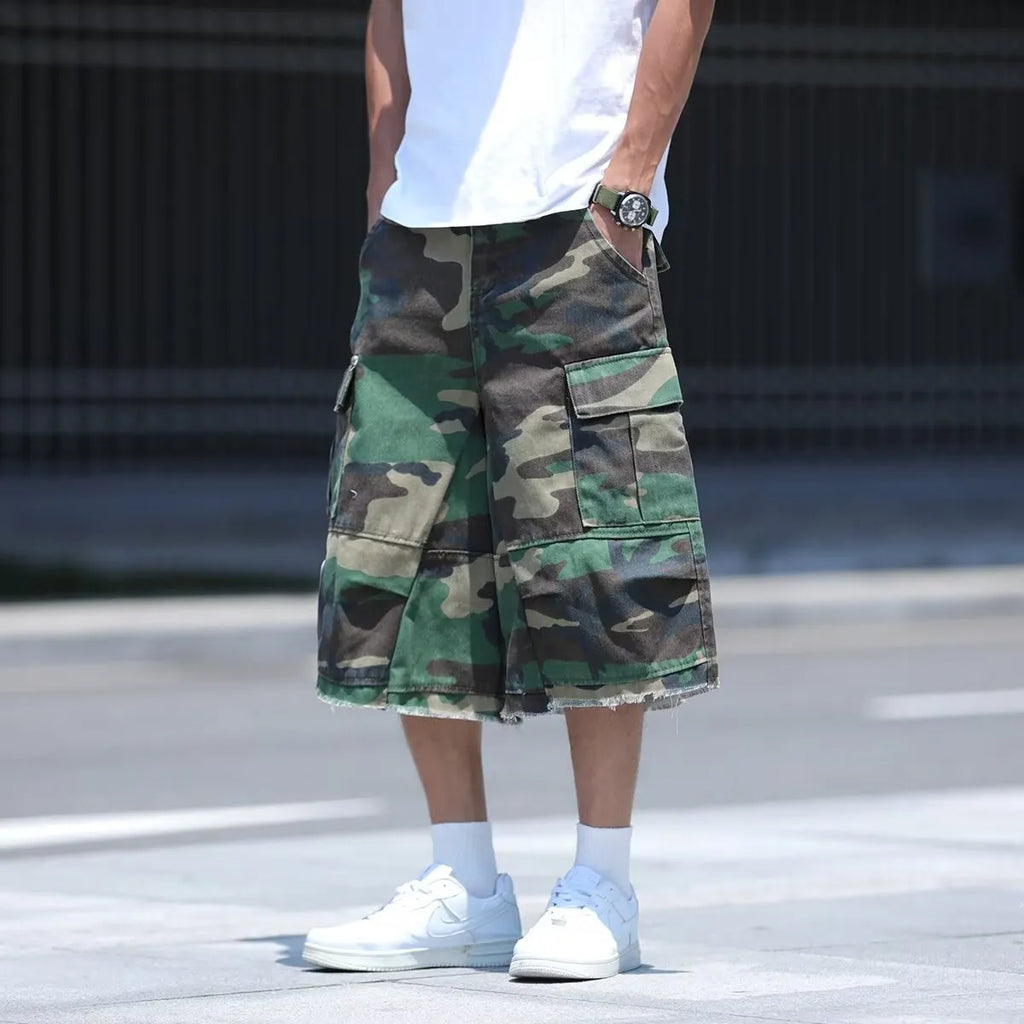 Men's loose-fit camouflage print shorts in retro workwear style on a white background.
