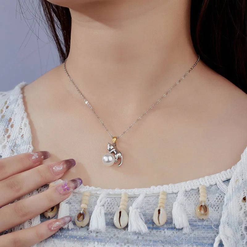 Sterling silver clavicle necklace with cat pendant on model, showing electroplated finish and professional styling
