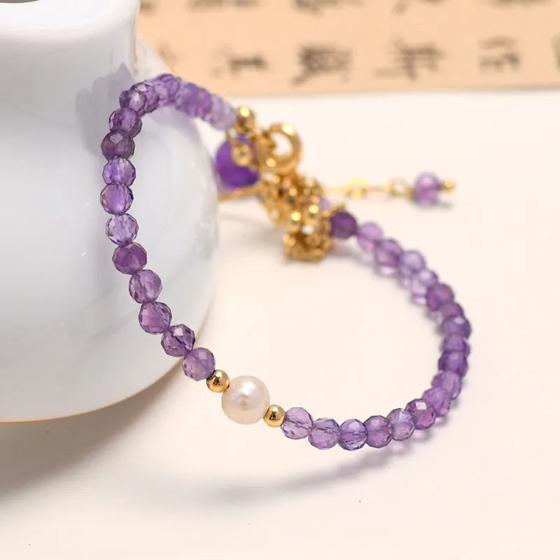 Chinese style women's bracelet with amethyst diamond-shaped crystals and electroplated finish.