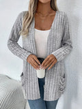 A loose-fit, solid colour long sleeve cardigan for women with a chest pocket, shown in grey and black.