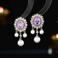 Oval zircon inlaid pearl tassel earrings in copper with geometric design and dangling elements
