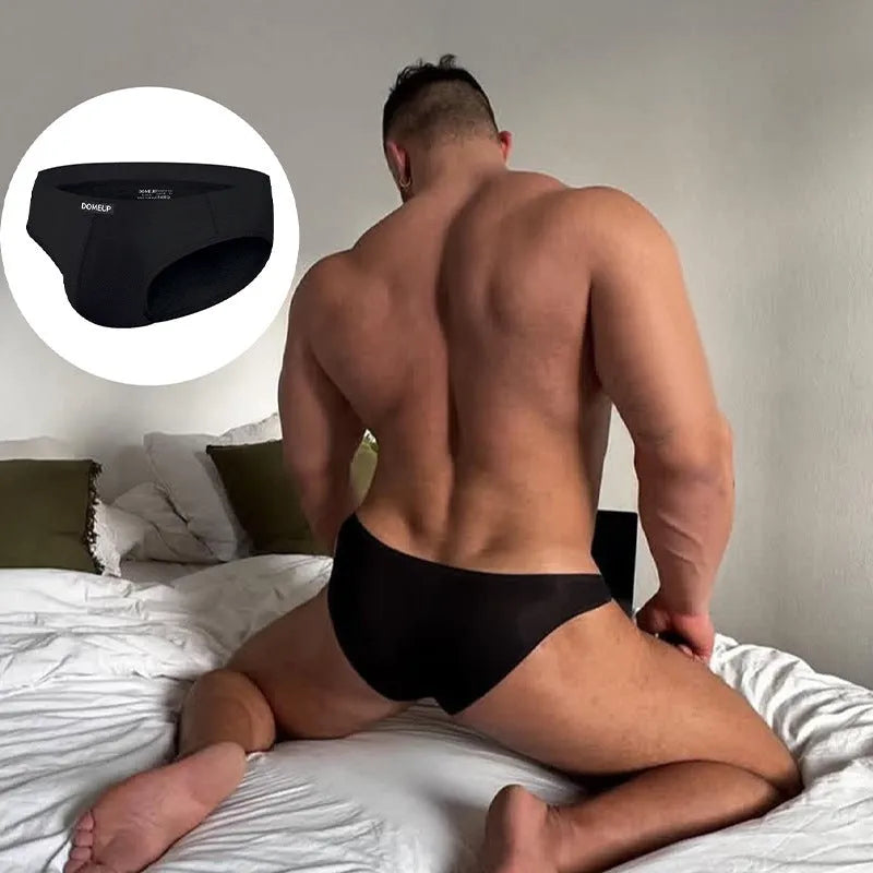 Men's solid colour low waist seamless briefs in black, white, and pink with breathable polyester fabric