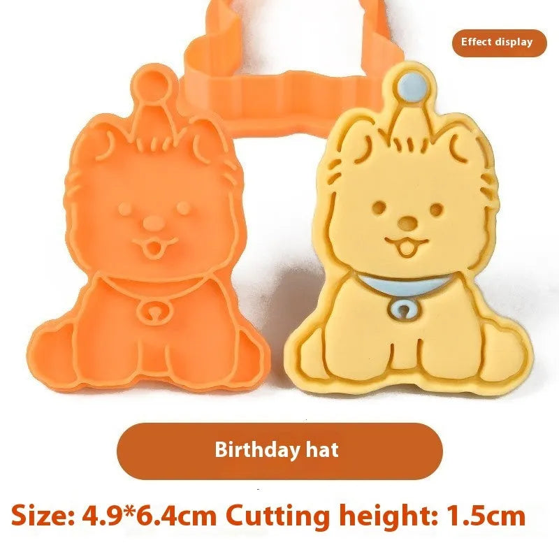 Three dimensional plastic biscuit mold showing puppy head and birthday hat designs