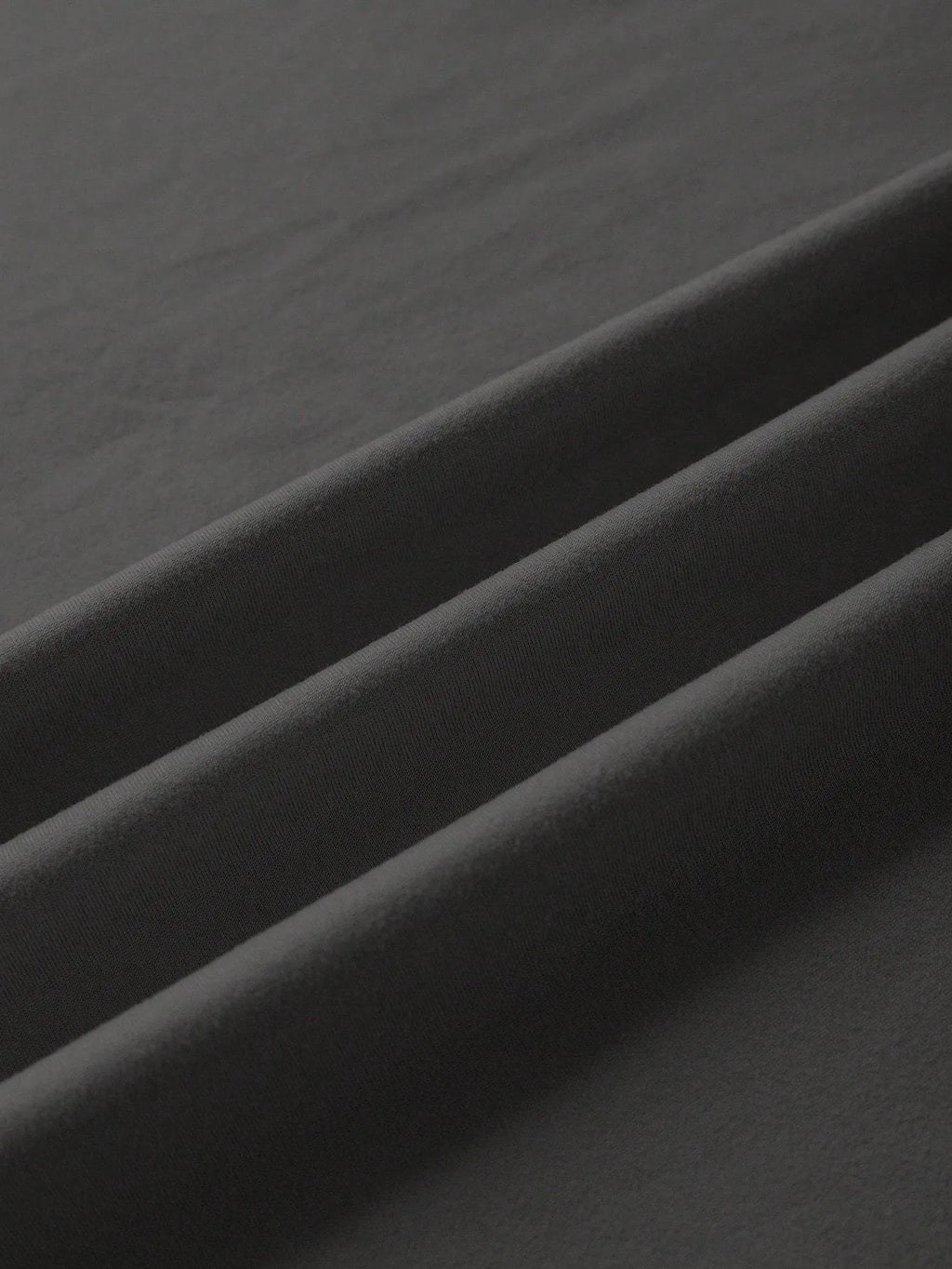 Straight-fit round neck cotton t-shirt in black, green, grey, or orange, shown with short sleeves.