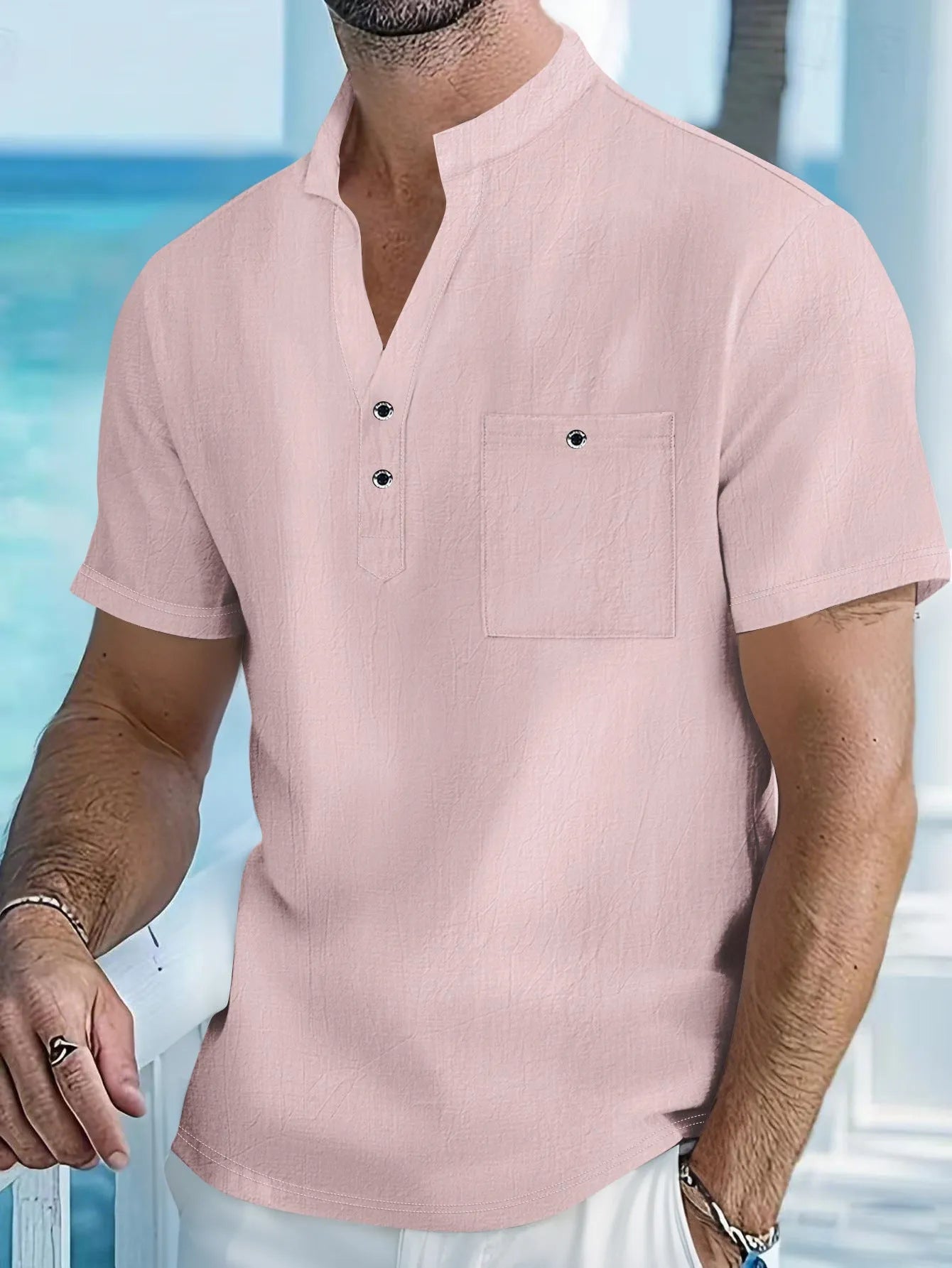 Man wearing a light-coloured linen stand collar short sleeve t-shirt in a relaxed fit.