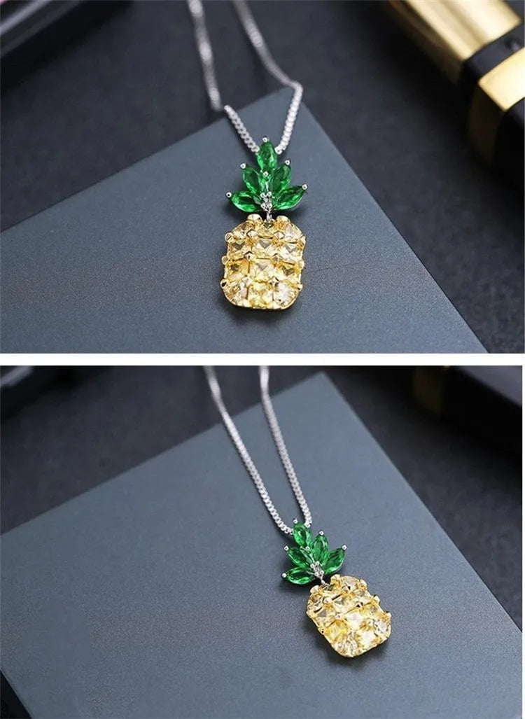 Silver geometric pineapple pendant necklace with diamond crystal details on women's model