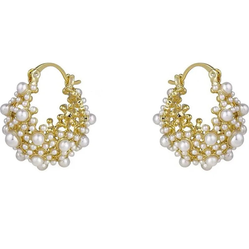 Gold-coloured copper flower basket earrings with small bead and pearl inlay detail.