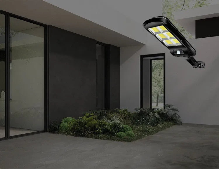 Black solar-powered outdoor street light with motion sensor for garden and driveway illumination