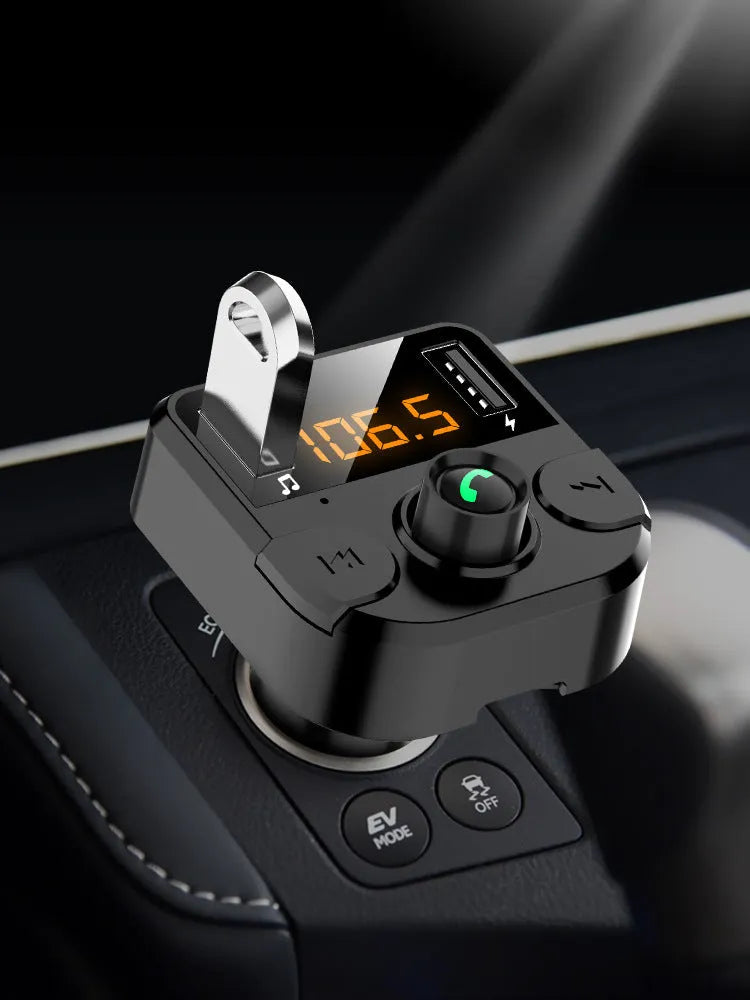 Black BT36B car Bluetooth MP3 player with 1.1-inch screen, plugged into a cigarette lighter.