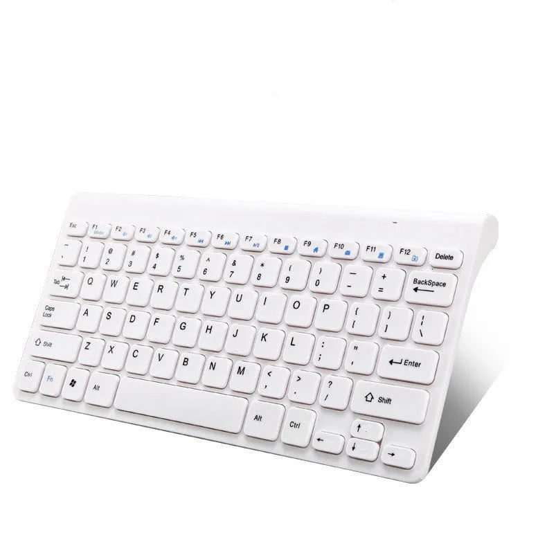 Black and white wireless keyboard and mouse set with USB receiver on a desk.