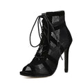 Black suede lace-up high heel women's shoes with 11.5cm heel on wooden surface
