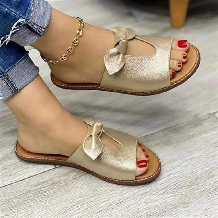 Women's black fish mouth sandals with a bow detail on the artificial PU upper and a rubber sole.