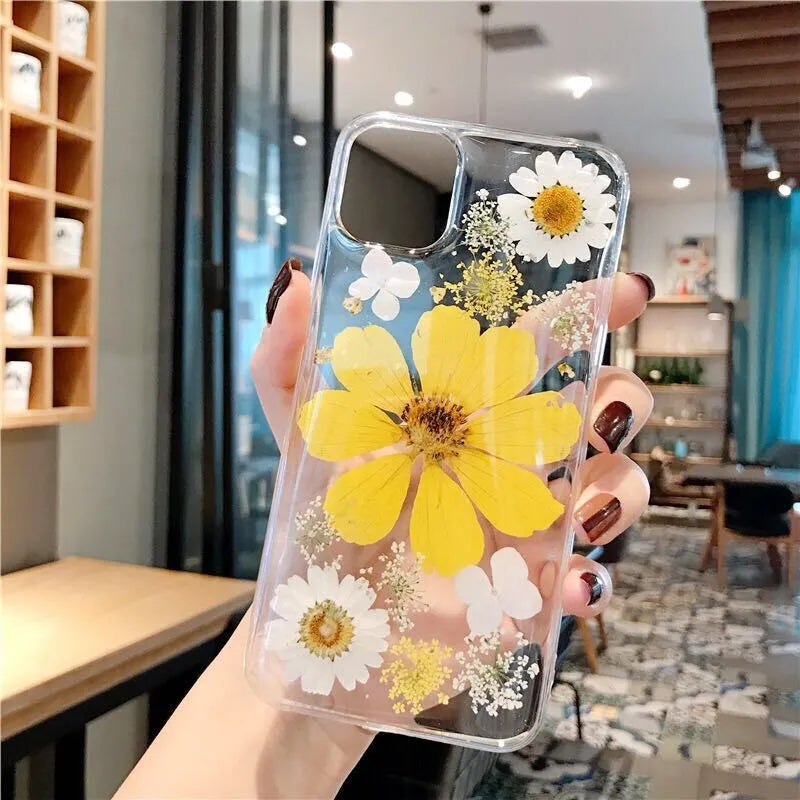 Floral pattern iPhone case in pink or yellow colour on a mobile phone