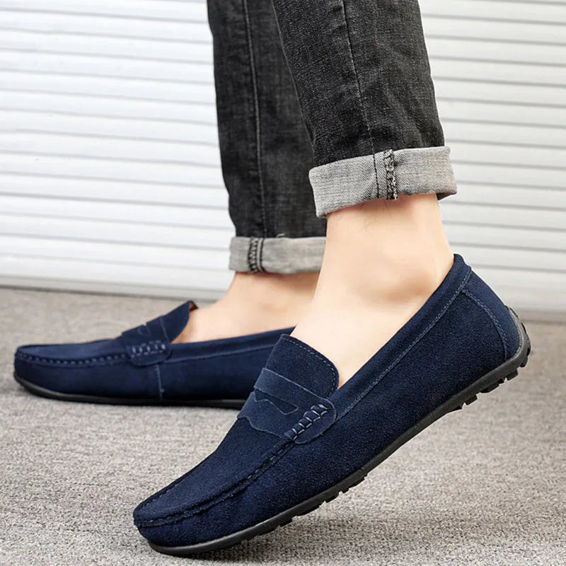 Men's suede slip-on loafers in a solid colour with a round toe and flat rubber sole.