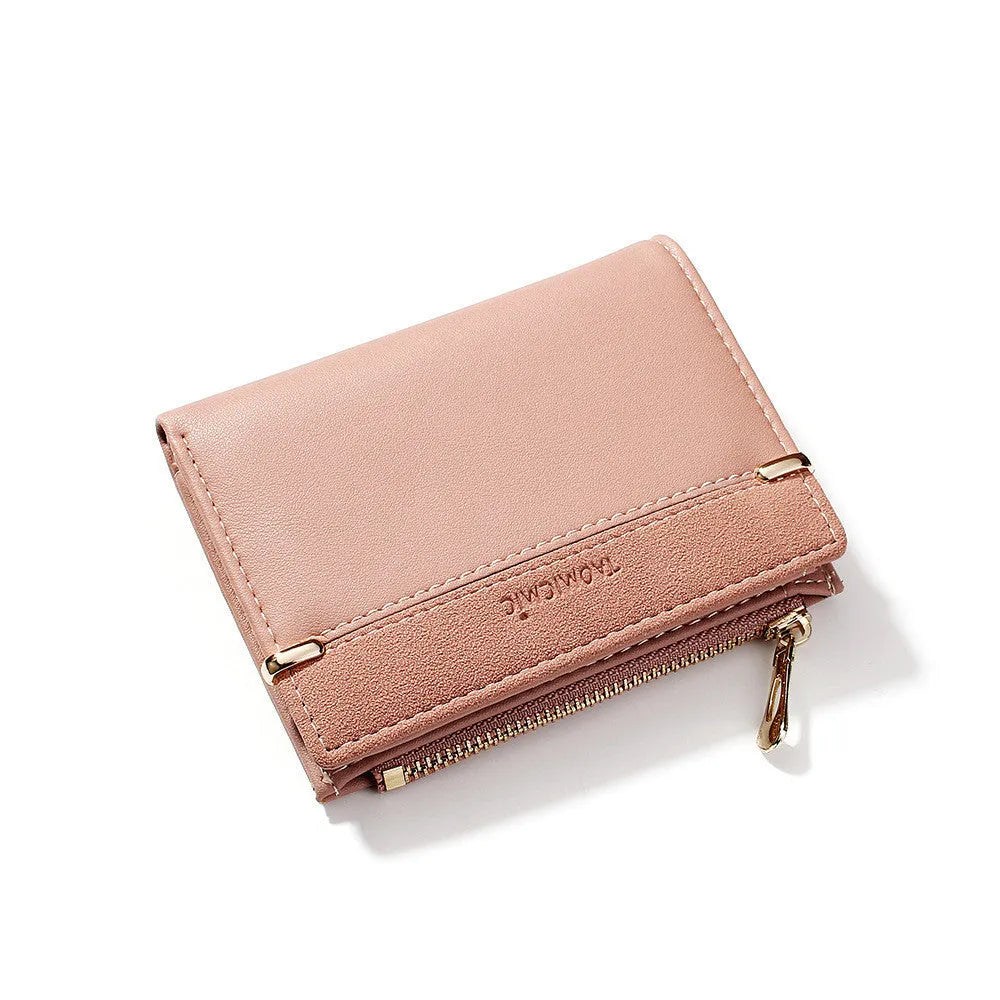 Black ladies folding wallet with a short zip, open to show multiple card slots, bill holder, and change compartment.