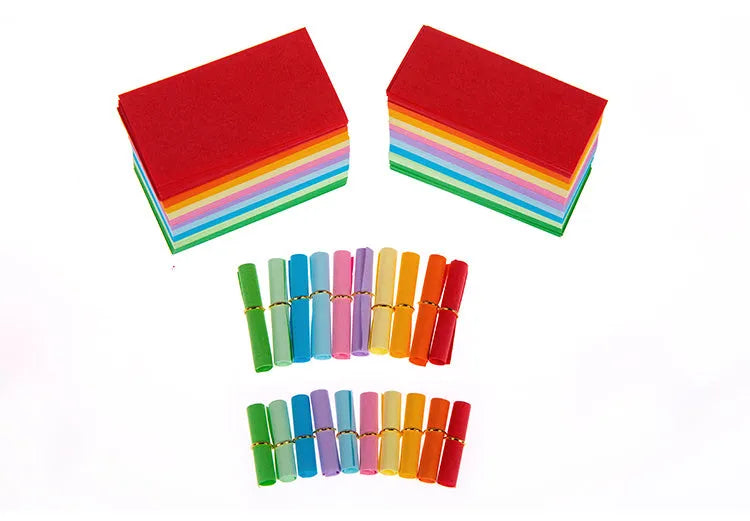 Colourful assortment of miniature rolled paper scrolls with metal eyelets for drift bottle messages.
