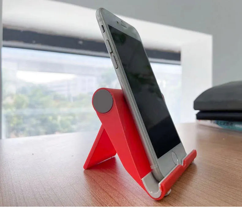 PE folding mobile phone stand in multiple colours showing multi-angle adjustment for tablets and smartphones