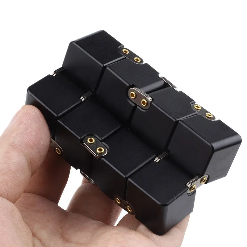 Silver zinc alloy infinity cube fidget toy with rotating segments shown on a flat surface