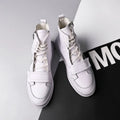 Black and white PU leather men's winter ankle boots in a high-top sneaker style on a size chart.