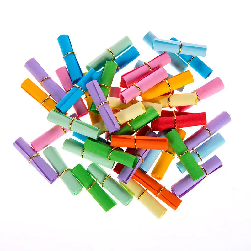 Colourful assortment of miniature rolled paper scrolls with metal eyelets for drift bottle messages.