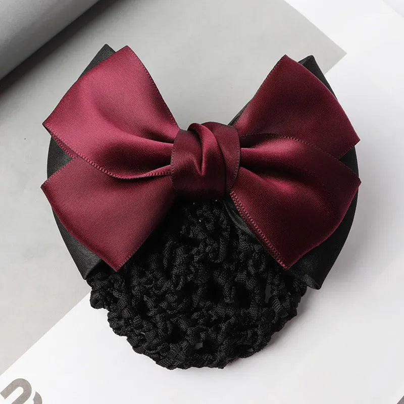 Professional flower bow headdress hair clip ornament on a work plate, shown in a selection of net and mesh colour variations.