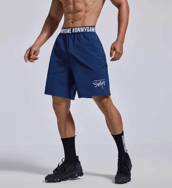 Men's loose fit cropped shorts in black with elastic fly opening and letter detailing