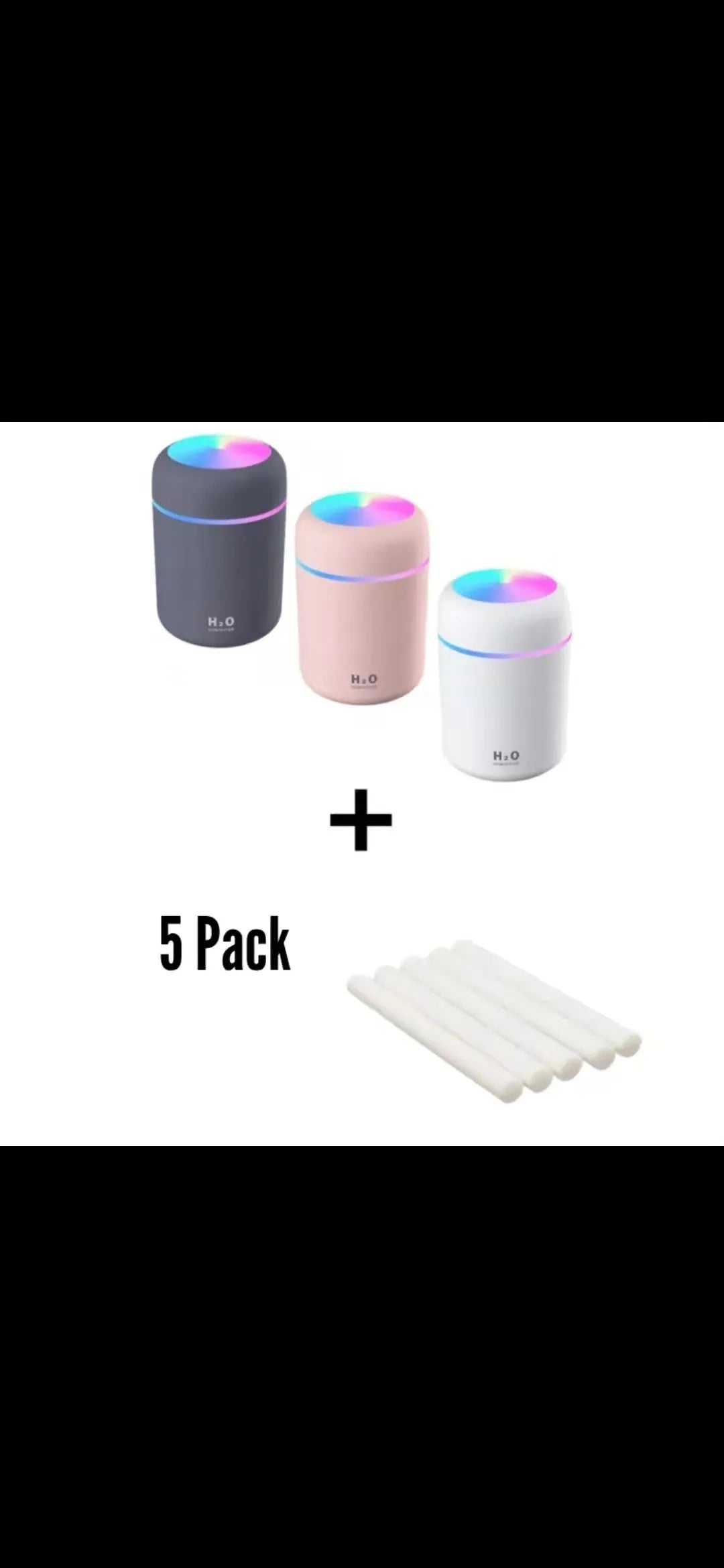 Pink USB desktop humidifier with coloured lights and water tank on a wooden desk