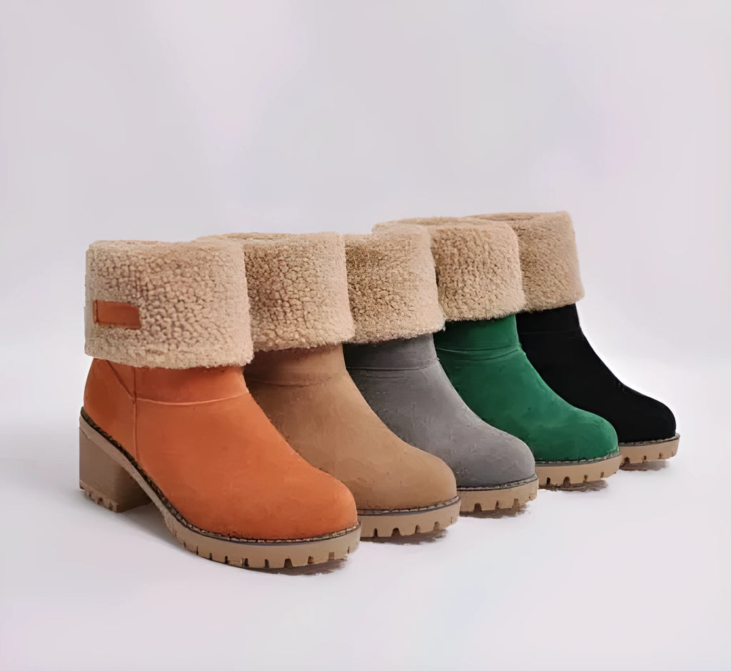 Women's black suede mid-tube knight snow boots with a thick sole and low flat heel on a plain background.