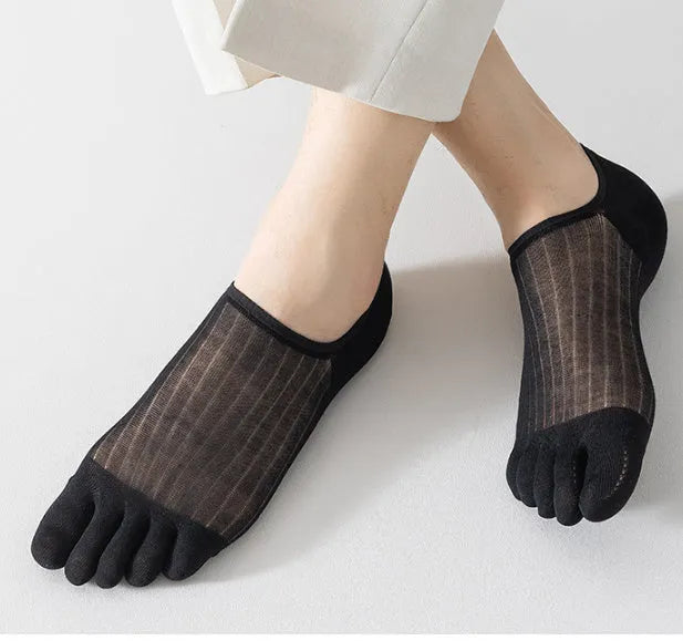 Pair of solid colour modal five-finger boat socks laid flat.