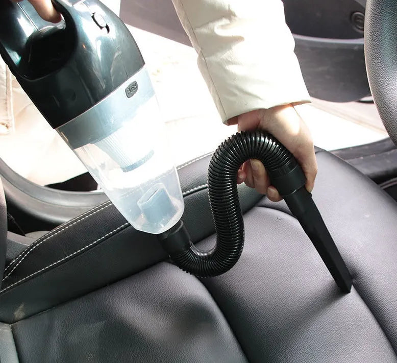 Orange, black, and blue 12V portable handheld car vacuum cleaner with nozzles.