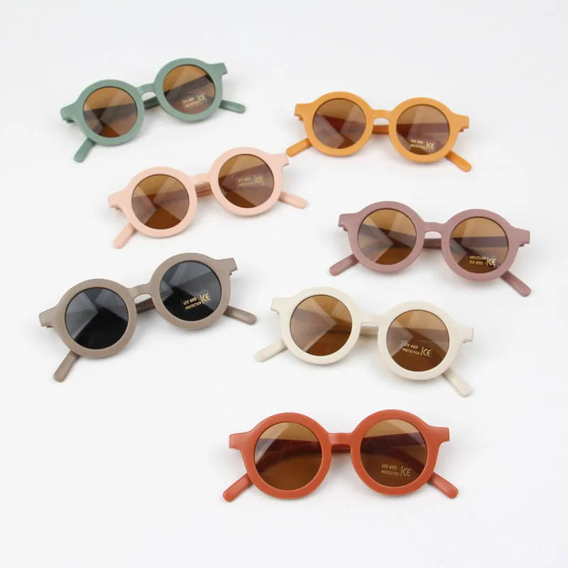 Children round frame retro mocha glasses on a child, showing the PC frame and resin lenses available in Beige, Brown, Green, Orange Red, Orange Yellow, Pink, and Purple colours