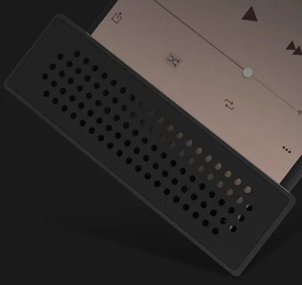 Portable Apple-compatible phone amplifier bracket in multiple colours on desktop