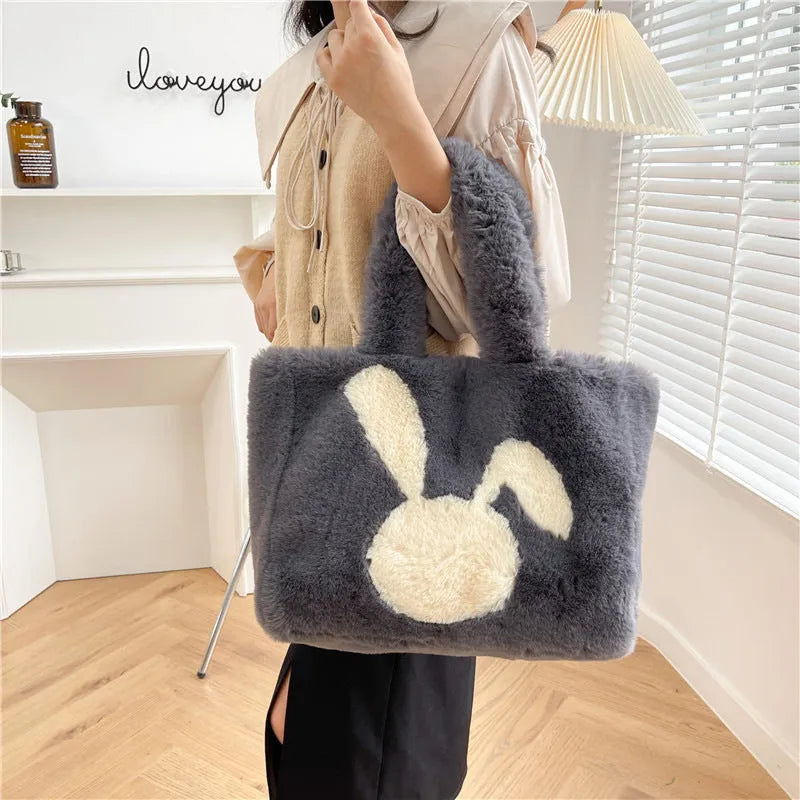 Plush shoulder bag with cartoon rabbit ears detail in solid colour