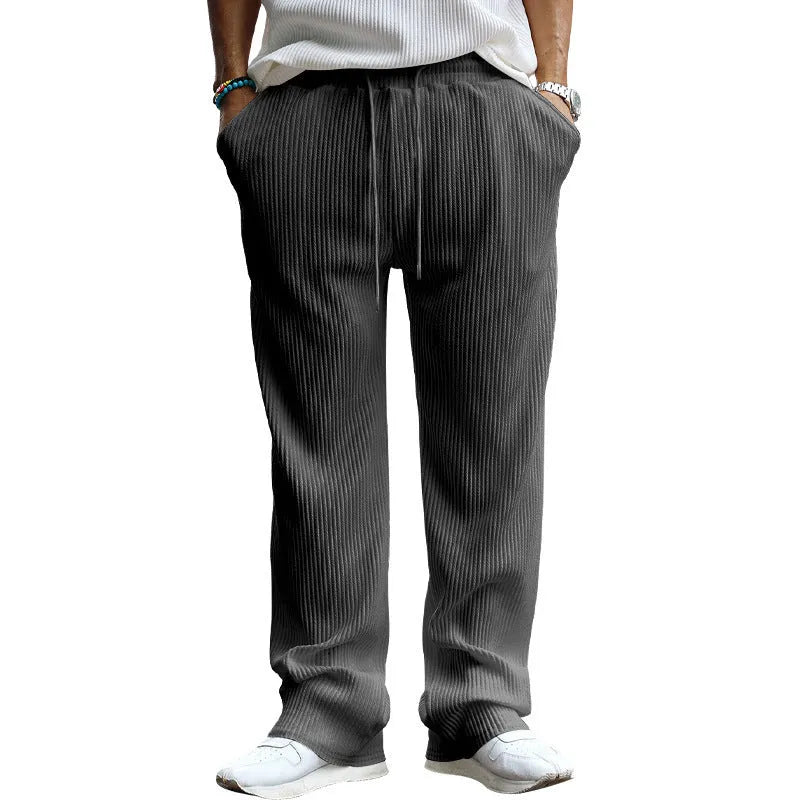 Man wearing army green striped high-waist straight-leg casual trousers.