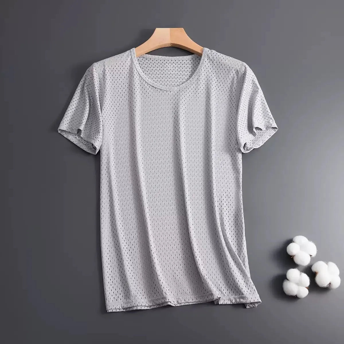 Man wearing a loose-fit ice silk short sleeve T-shirt in a solid colour.