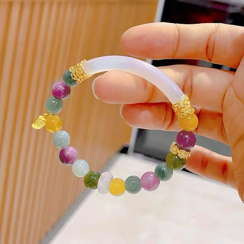 Rainbow-coloured women's half bracelet made from natural tourmaline with a pith centrepiece.