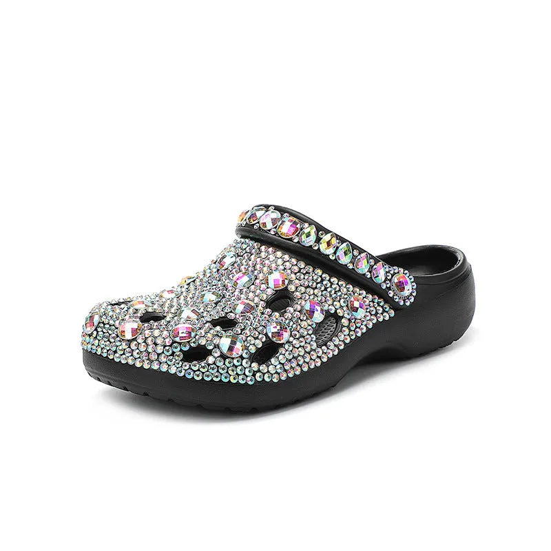 Black women's platform sandals covered in rhinestones with a chunky EVA sole.